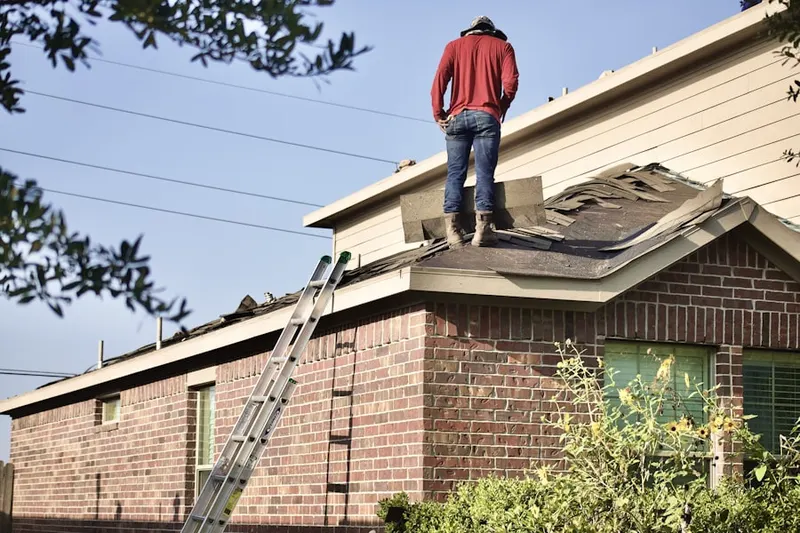 Professional roofer working on a residential roof in Lemay